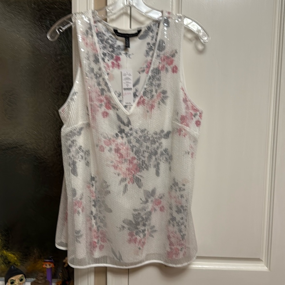 Sleeveless dress top with overlay over floral print.